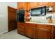 Cozy kitchen with wooden cabinets, oven, microwave, and tiled backsplash at 431 N Bauman St, Indianapolis, IN 46214