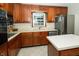 Kitchen with stainless steel refrigerator, wooden cabinets, and stainless dishwasher at 431 N Bauman St, Indianapolis, IN 46214