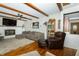 The living room has hardwood floors, beams, fireplace and comfortable sectional sofa at 431 N Bauman St, Indianapolis, IN 46214