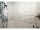 Bathtub and shower featuring subway tile and decorative shower curtain at 431 N Bauman St, Indianapolis, IN 46214