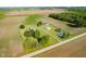 Expansive aerial shot of the property, featuring the house, outbuildings, and surrounding farmland at 4330 S 100 E, Lebanon, IN 46052