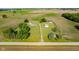 Stunning aerial perspective showcasing the home's setting amidst open fields and lush greenery at 4330 S 100 E, Lebanon, IN 46052