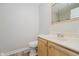 A well-lit bathroom featuring a wood vanity, a large framed mirror, and neutral wall, providing a clean, serene space at 4330 S 100 E, Lebanon, IN 46052