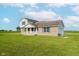 Two-story home with a brick facade, vinyl siding, attached garage, and well-kept lawn at 4330 S 100 E, Lebanon, IN 46052