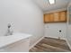 Functional laundry room with a utility sink and wooden cabinets at 4330 S 100 E, Lebanon, IN 46052