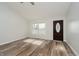Bright living room with hardwood floors, a window with a view, and a dark wood door at 4330 S 100 E, Lebanon, IN 46052