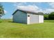 A gray shed sits on a large lawn, offering additional storage and practical use for your property needs at 4330 S 100 E, Lebanon, IN 46052