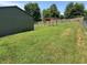 Beautiful green backyard with a shed, wooden pergola, swing set, and a well-maintained lawn at 4466 Buffalo Ln, Martinsville, IN 46151