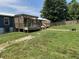 Landscaped backyard featuring a wooden deck with pergola and lovely, lush green grass and manicured path leading to the house at 4466 Buffalo Ln, Martinsville, IN 46151