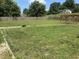 A spacious backyard with lush green grass, a wooden fence, a pergola with a swing set, and a well-maintained lawn at 4466 Buffalo Ln, Martinsville, IN 46151