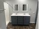 Bathroom with modern double sinks, dark blue cabinets, white shower at 4466 Buffalo Ln, Martinsville, IN 46151