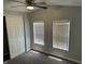 Bedroom with neutral walls, carpet flooring, a ceiling fan, closet, and natural light from two windows at 4466 Buffalo Ln, Martinsville, IN 46151