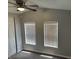 Cozy bedroom with neutral walls, carpet flooring, a ceiling fan, and two windows at 4466 Buffalo Ln, Martinsville, IN 46151