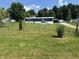 Beautiful home exterior with a spacious front yard, green grass, well-maintained lawn, and a driveway at 4466 Buffalo Ln, Martinsville, IN 46151