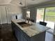 Stylish kitchen featuring island with sink and seating with sliding door access to backyard at 4466 Buffalo Ln, Martinsville, IN 46151