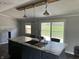 Stylish kitchen featuring island with sink and seating with sliding door access to backyard at 4466 Buffalo Ln, Martinsville, IN 46151