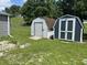 Backyard with sheds and green grass. Well-maintained lawn and tidy property with multiple storage sheds at 4466 Buffalo Ln, Martinsville, IN 46151
