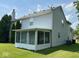 View of the home's back exterior featuring an enclosed sunroom at 4912 Atlanta St, Anderson, IN 46013