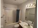 Bathroom featuring a vanity, tub-shower combo, a blue shower curtain and neutral tile flooring at 4912 Atlanta St, Anderson, IN 46013