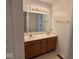 Bathroom featuring a double sink vanity, ample counter space, and a large mirror, with overhead lighting at 4912 Atlanta St, Anderson, IN 46013