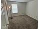 Bedroom featuring neutral walls, carpet, a lamp, and a window allowing natural light at 4912 Atlanta St, Anderson, IN 46013