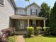 Inviting front porch and landscaped garden at 4912 Atlanta St, Anderson, IN 46013