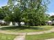 Lush front yard featuring mature trees and green grass at 4912 Atlanta St, Anderson, IN 46013