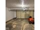 This is a spacious garage with ample room for parking and storage, featuring an orange lawn tractor at 4912 Atlanta St, Anderson, IN 46013