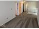 Upstairs hallway featuring neutral carpet and access to multiple rooms, creating a seamless flow at 4912 Atlanta St, Anderson, IN 46013