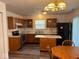 A kitchen area with natural wood cabinets, black appliances, and a kitchen island at 4912 Atlanta St, Anderson, IN 46013