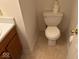 A small bathroom with toilet, sink, and neutral colors at 4912 Atlanta St, Anderson, IN 46013