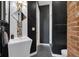 Modern bathroom featuring black and white tiling, exposed brick, and unique sink at 501 Fletcher Ave # A, Indianapolis, IN 46203