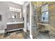 Modern bathroom features a walk-in shower, dual vanity sinks, and stylish stone tile accents at 501 Fletcher Ave # A, Indianapolis, IN 46203
