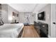 Bedroom with a stone accent wall, laminate flooring, and exercise equipment at 501 Fletcher Ave # A, Indianapolis, IN 46203