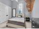 Light-filled bedroom with original exposed brick wall and comfortable sleeping space at 501 Fletcher Ave # A, Indianapolis, IN 46203