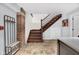 Hallway features tiled floors, wooden staircase, and exposed brick wall at 501 Fletcher Ave # A, Indianapolis, IN 46203