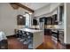 A modern kitchen features dark cabinetry, stainless appliances, hardwood floors, and a large island with barstool seating at 501 Fletcher Ave # A, Indianapolis, IN 46203