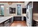 Modern kitchen features stainless steel appliances, dark cabinets, and natural light from large windows at 501 Fletcher Ave # A, Indianapolis, IN 46203