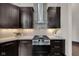 Gourmet kitchen with stainless steel range, custom cabinets, and modern vent hood at 501 Fletcher Ave # A, Indianapolis, IN 46203