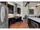 Stylish kitchen features dark wood cabinetry, stainless steel appliances, and a view to the staircase at 501 Fletcher Ave # A, Indianapolis, IN 46203