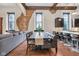 Living and dining area with dark cabinets, seating and hardwood floors at 501 Fletcher Ave # A, Indianapolis, IN 46203