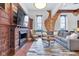 Living room featuring a fireplace, decorative wood paneling, and ample seating at 501 Fletcher Ave # A, Indianapolis, IN 46203