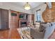 Spacious living room with fireplace, TV, and exposed brick accent wall at 501 Fletcher Ave # A, Indianapolis, IN 46203