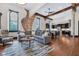 Open-concept living area with exposed brick, hardwood floors, and modern furnishings at 501 Fletcher Ave # A, Indianapolis, IN 46203