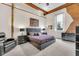 Bright main bedroom with exposed brick, wood beam ceiling, and modern furnishings at 501 Fletcher Ave # A, Indianapolis, IN 46203