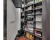 Walk-in pantry features dark shelves stocked with various food items and household supplies at 501 Fletcher Ave # A, Indianapolis, IN 46203