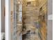 Walk-in shower with stone tile surround, built-in bench, and dual shower heads at 501 Fletcher Ave # A, Indianapolis, IN 46203