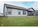 A tranquil backyard features a well-maintained lawn, with a glimpse of the covered patio at 5081 Holborn Ave, McCordsville, IN 46055
