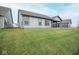 A tranquil backyard features a well-maintained lawn, with a glimpse of the covered patio at 5081 Holborn Ave, McCordsville, IN 46055