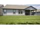 Back of a gray single Gathering home showing the backyard, patio and manicured lawn at 5081 Holborn Ave, McCordsville, IN 46055
